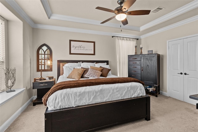 bedroom featuring light colored carpet, visible vents, crown molding, and baseboards