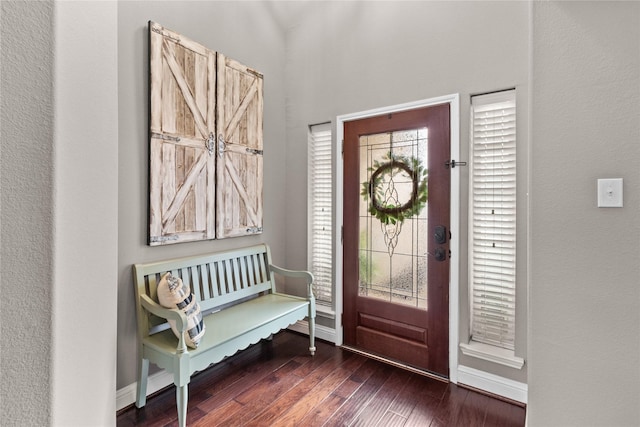 foyer featuring wood-type flooring and baseboards