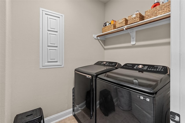 washroom featuring laundry area, washing machine and dryer, and baseboards