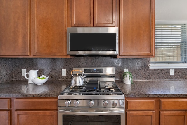 kitchen with stainless steel appliances and backsplash