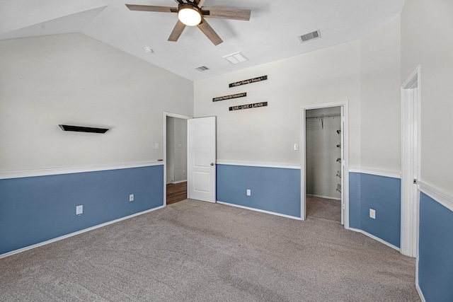 unfurnished room with visible vents, baseboards, ceiling fan, carpet flooring, and high vaulted ceiling