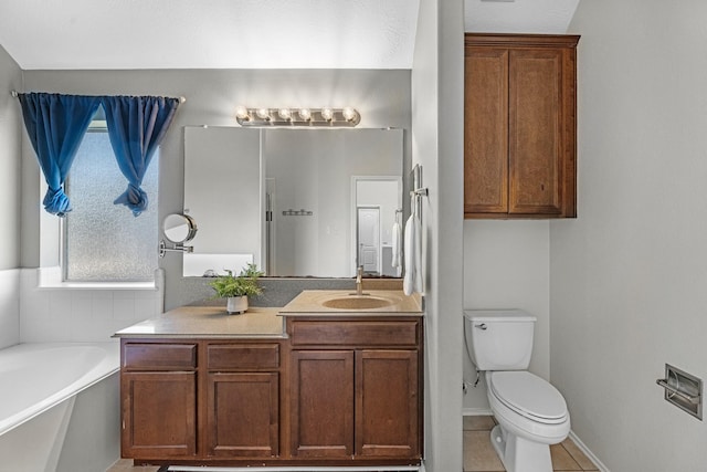 bathroom featuring a garden tub, toilet, vanity, tile patterned flooring, and baseboards