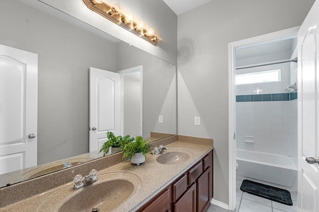 full bathroom featuring double vanity, tile patterned flooring, a sink, and toilet