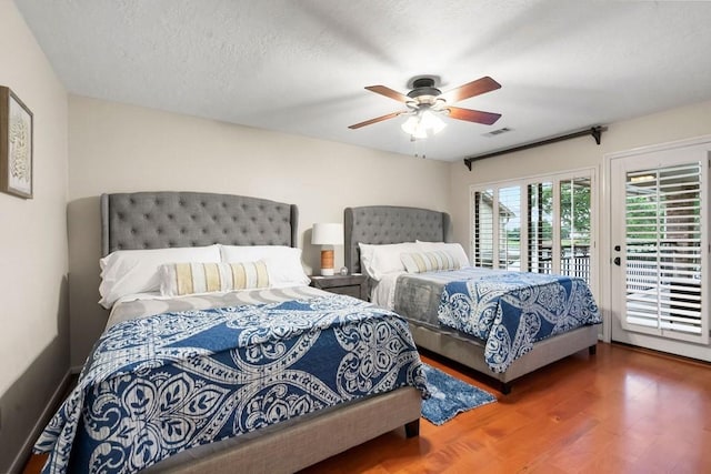 bedroom with visible vents, a ceiling fan, a textured ceiling, wood finished floors, and access to outside