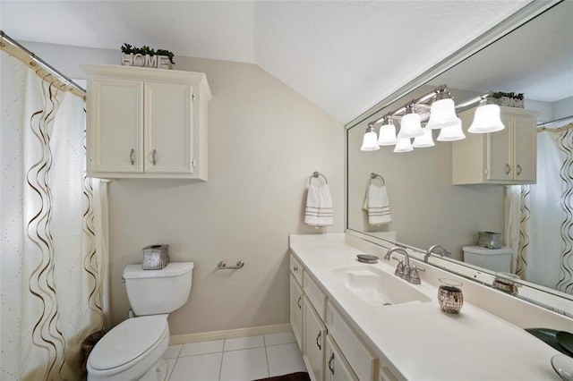 bathroom featuring toilet, vaulted ceiling, vanity, baseboards, and tile patterned floors