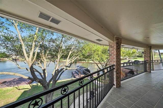 balcony with a water view and visible vents