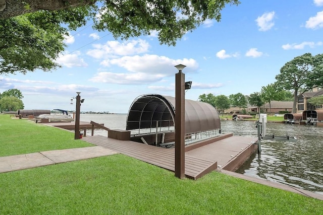 dock area featuring a water view and a lawn