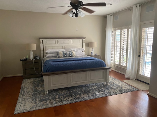 bedroom featuring visible vents, ceiling fan, a textured ceiling, wood finished floors, and baseboards