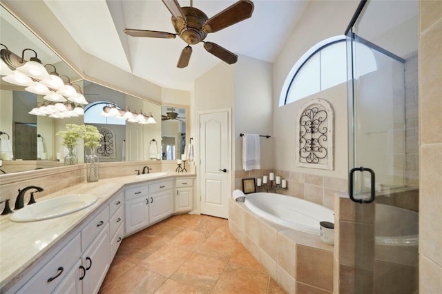 full bath with lofted ceiling, a stall shower, double vanity, and a sink