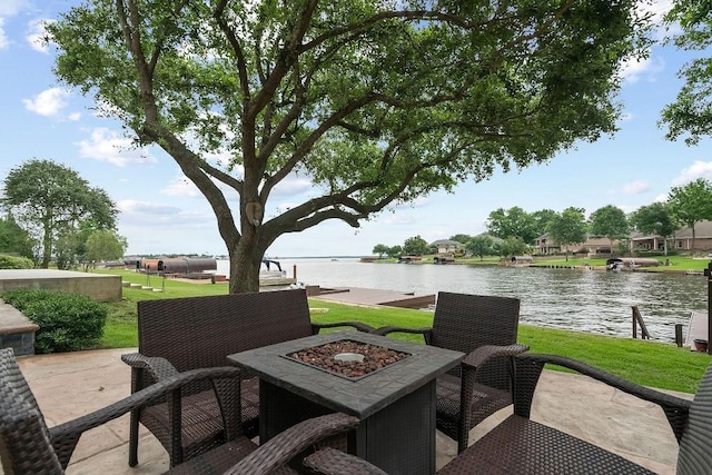 view of patio / terrace featuring a water view and a fire pit