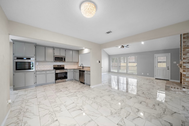 kitchen featuring gray cabinetry, visible vents, marble finish floor, light countertops, and appliances with stainless steel finishes