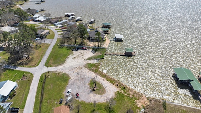 birds eye view of property with a water view and a residential view