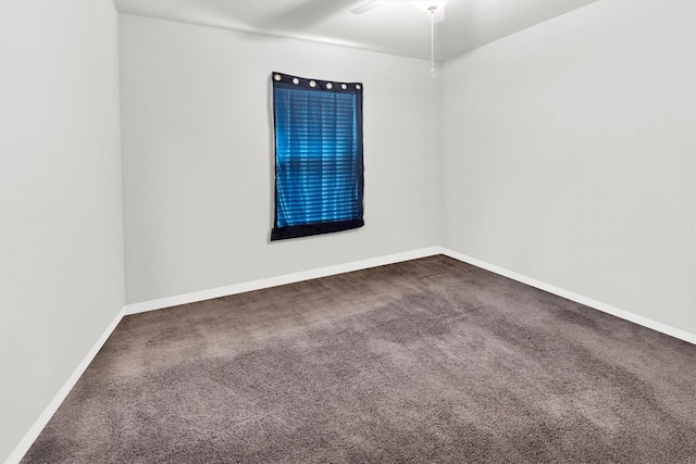 spare room featuring carpet, a ceiling fan, and baseboards