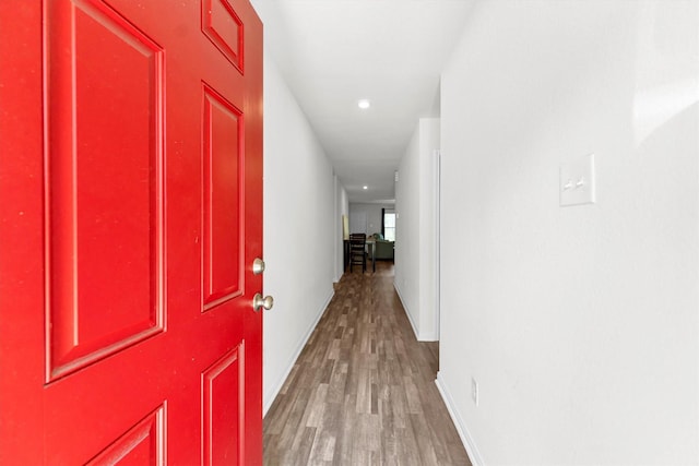 hall with light wood finished floors and baseboards