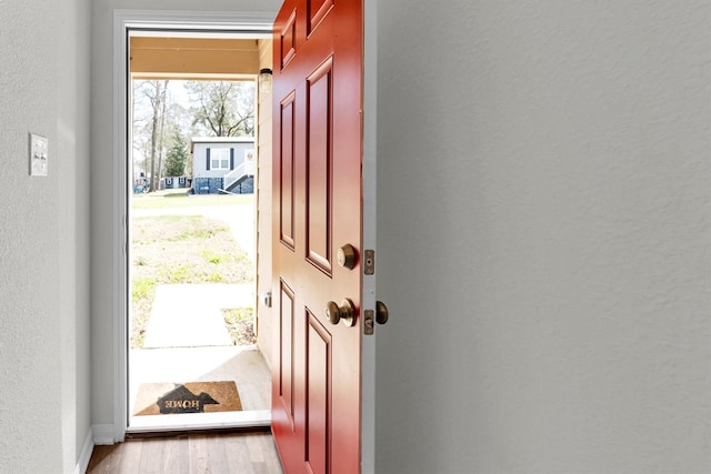 entryway with a textured wall and wood finished floors