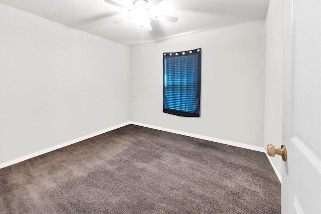 empty room with dark carpet, baseboards, and ceiling fan