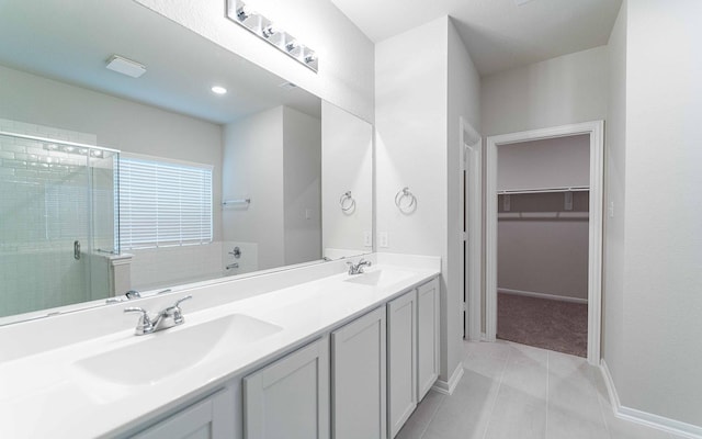 8125 Coral Dr, Texas City, TX 77591 - full bath featuring a shower stall, double vanity, tile patterned flooring, baseboards, and a walk in closet