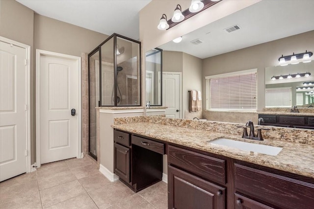 bathroom featuring visible vents, a stall shower, tile patterned flooring, and vanity