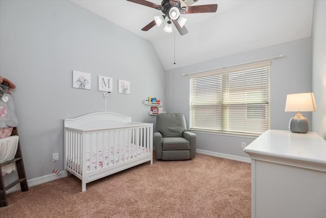 bedroom with baseboards, vaulted ceiling, a crib, and light colored carpet