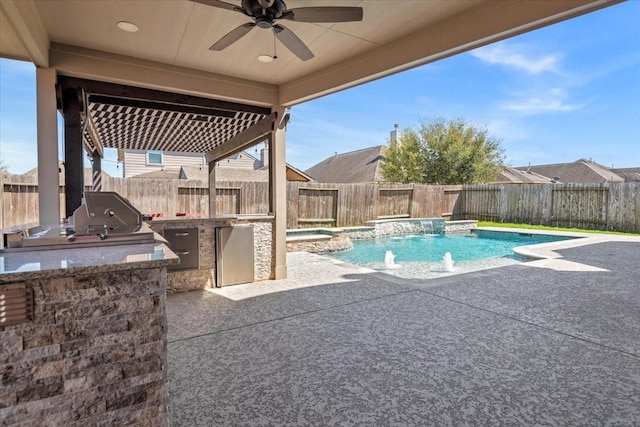 view of swimming pool with an outdoor kitchen, a ceiling fan, area for grilling, a fenced backyard, and a patio