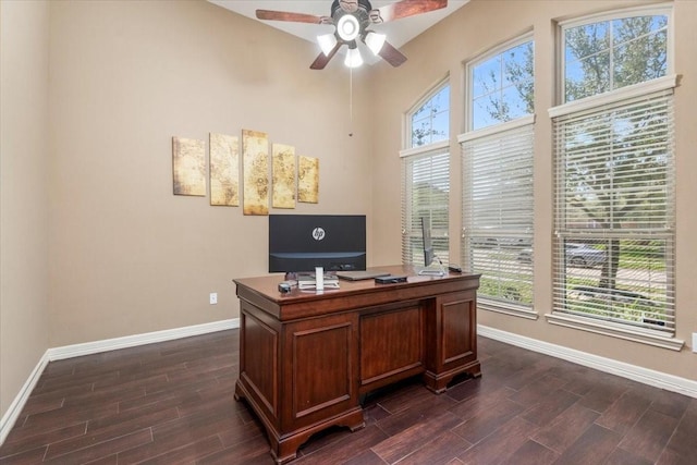 office space featuring plenty of natural light, baseboards, ceiling fan, and wood finish floors
