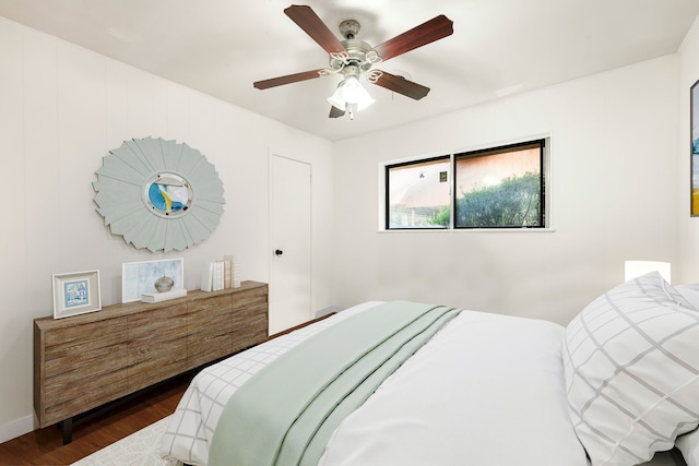 bedroom featuring dark wood-style floors, ceiling fan, and baseboards