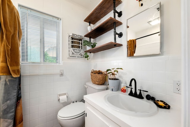 full bath with a wainscoted wall, tile walls, toilet, vanity, and a shower with curtain