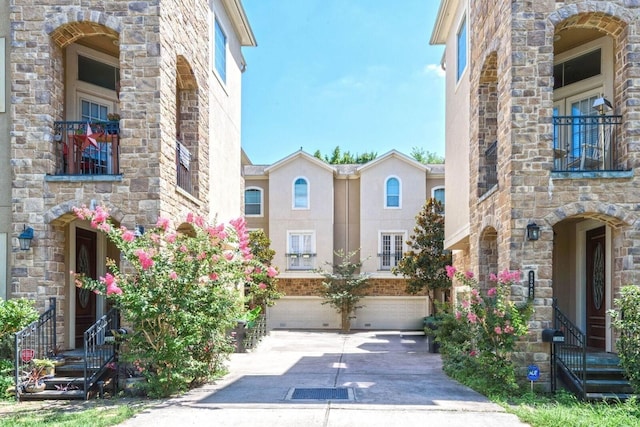 exterior space with driveway, a balcony, and a garage