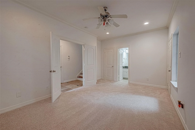 unfurnished bedroom featuring light carpet, baseboards, crown molding, and recessed lighting