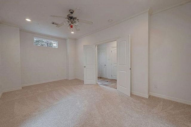 unfurnished bedroom featuring ceiling fan, recessed lighting, light carpet, baseboards, and crown molding