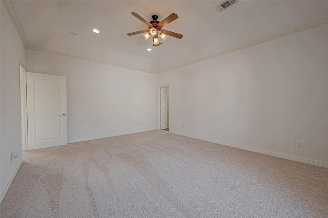 empty room featuring baseboards, carpet, visible vents, and crown molding