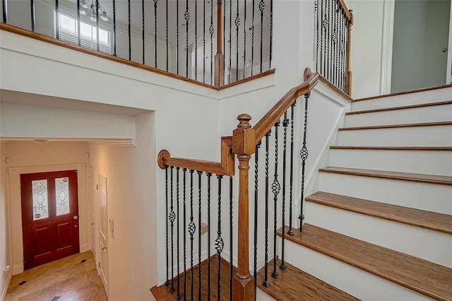 staircase featuring a high ceiling