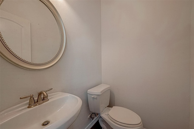 half bathroom with a sink and toilet