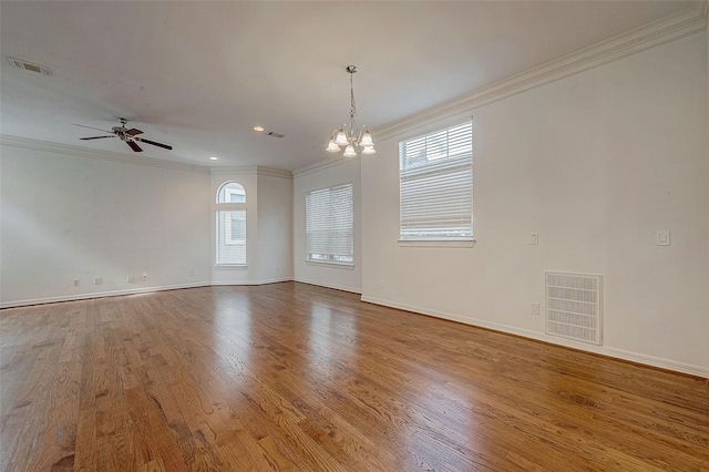 unfurnished room with ornamental molding, wood finished floors, and visible vents