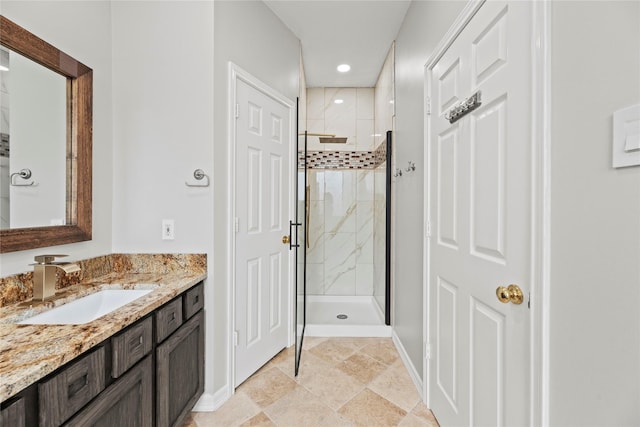 bathroom with a stall shower, vanity, baseboards, and recessed lighting