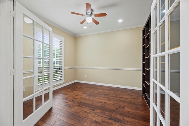 unfurnished room featuring ornamental molding, a ceiling fan, hardwood / wood-style flooring, and baseboards