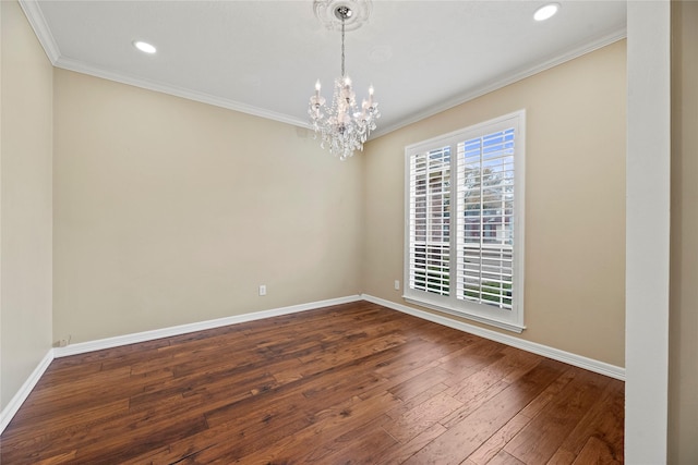 spare room featuring ornamental molding, dark wood-style flooring, and baseboards