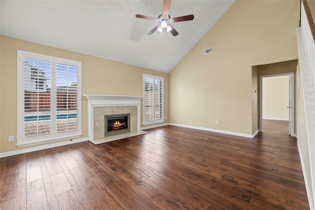 unfurnished living room featuring a fireplace, visible vents, dark wood-type flooring, a ceiling fan, and baseboards