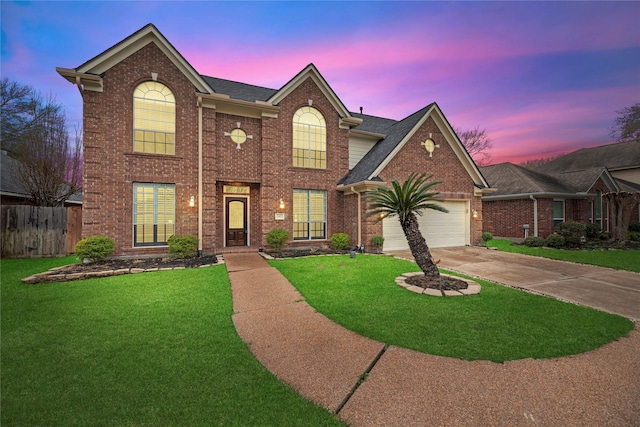 traditional-style home with driveway, an attached garage, a front lawn, and brick siding