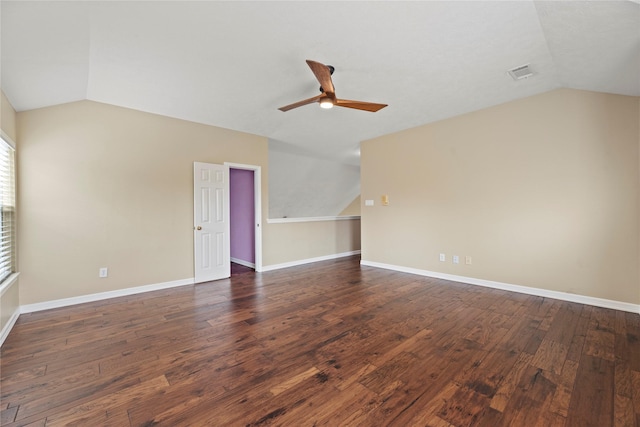 interior space featuring lofted ceiling, baseboards, and dark wood-style flooring