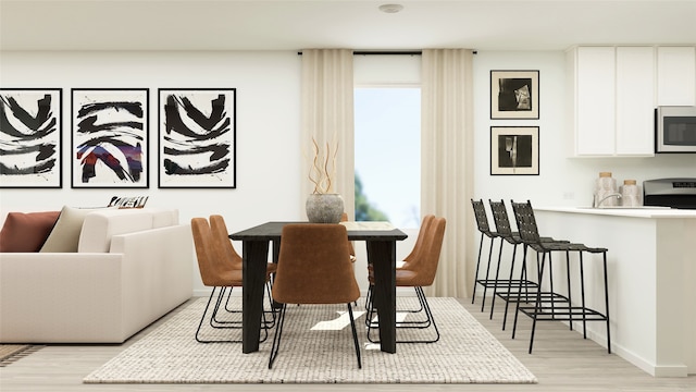 dining area featuring light wood-style floors and baseboards