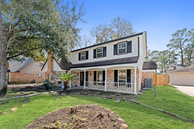 traditional-style home with brick siding, covered porch, fence, central AC, and a front yard