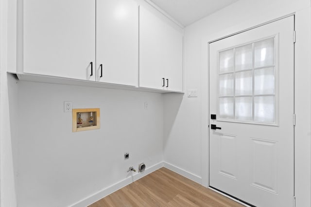 clothes washing area featuring washer hookup, light wood finished floors, cabinet space, hookup for an electric dryer, and baseboards