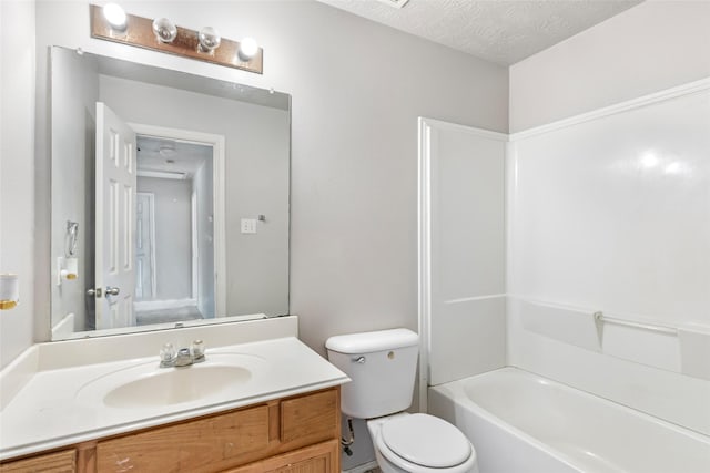 full bathroom featuring vanity, toilet, and a textured ceiling