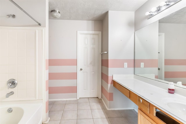 full bath with a textured ceiling, baseboards, vanity, and tile patterned floors