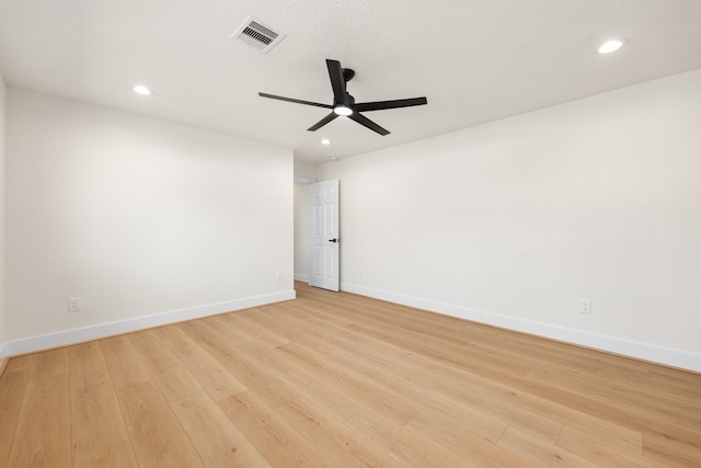 empty room featuring recessed lighting, visible vents, light wood-style flooring, ceiling fan, and baseboards