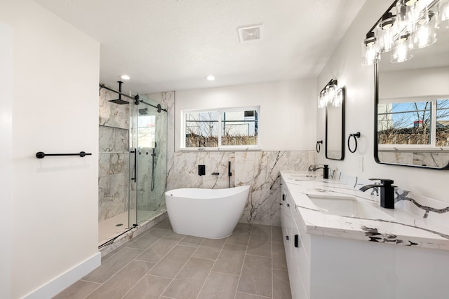 full bathroom featuring a wealth of natural light, visible vents, a sink, and a marble finish shower