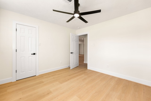 unfurnished bedroom with a ceiling fan, baseboards, and light wood finished floors