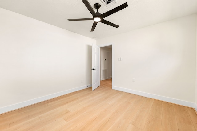 unfurnished room with visible vents, ceiling fan, light wood-style flooring, and baseboards