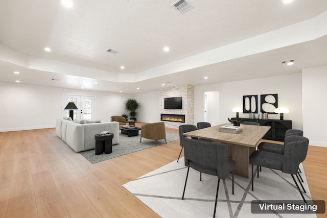 dining area featuring recessed lighting, a fireplace, visible vents, baseboards, and light wood-style floors